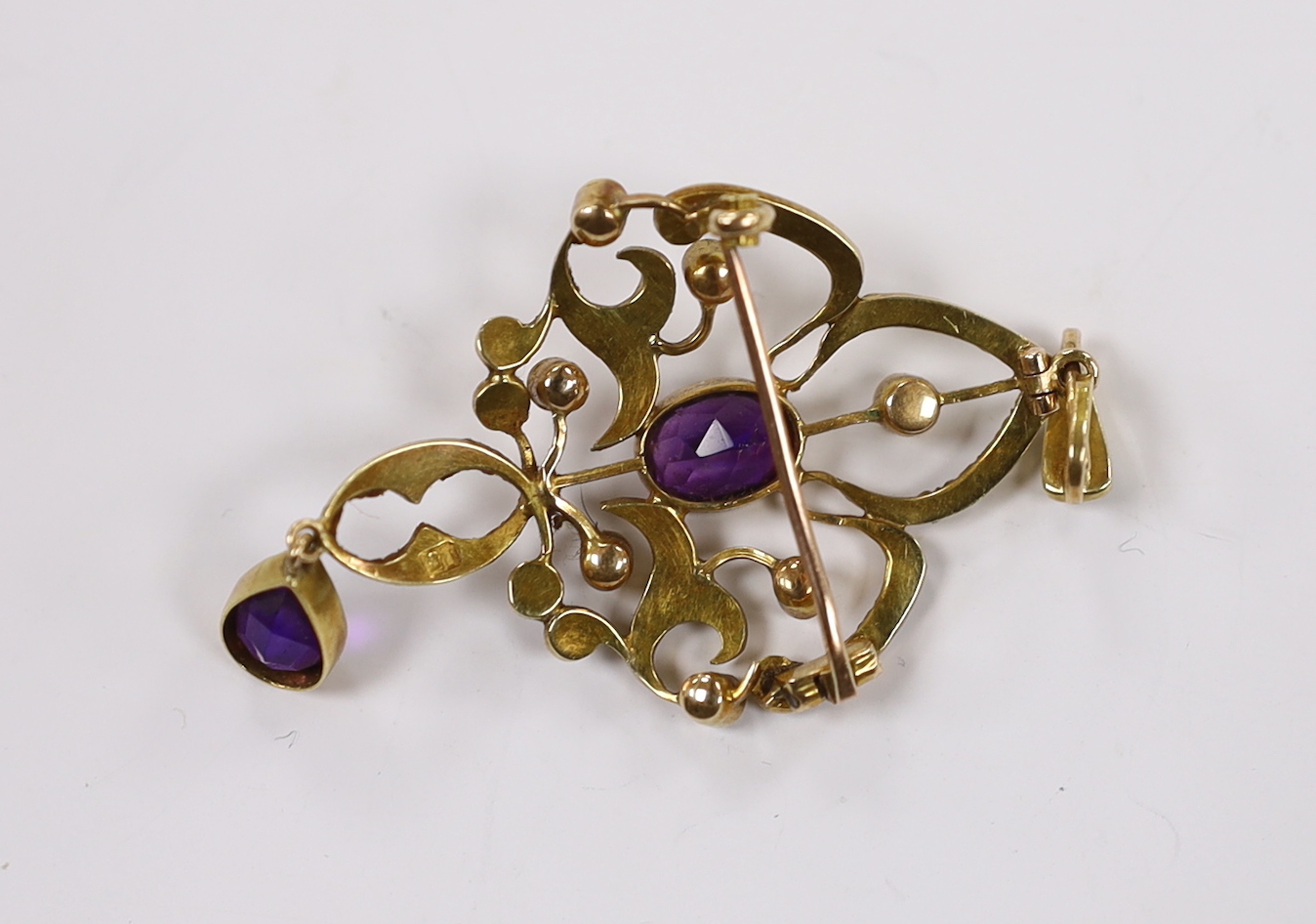 A late Victorian 15ct, amethyst and seed pearl cluster set drop pendant brooch, 55mm, gross weight 5.6 grams.